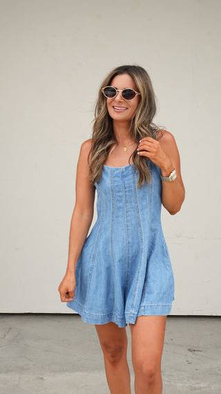 Woman wearing the Paneled Denim Romper, a medium wash denim romper from COCO The Shop Dublin Ohio boutique