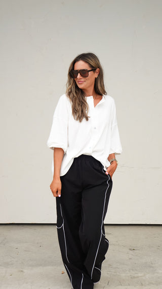 Close-up of the button-front detail on the White Button-Front Short Sleeve Top from COCO The Shop Dublin Ohio