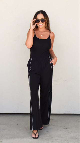 Woman wearing the Black Nylon Track Pants, elevated women's athleisure from COCO The Shop Dublin Ohio boutique