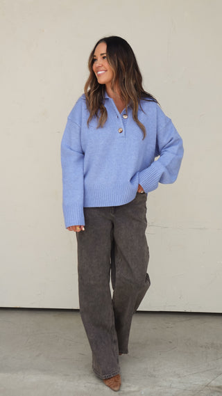 Women's blue collared slouchy knit sweater styled with light wash denim shorts