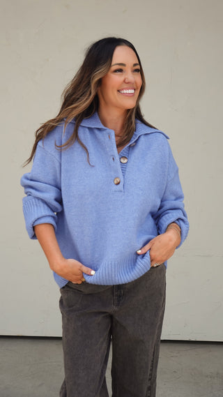 Women's blue collared slouchy knit sweater styled with light wash denim shorts