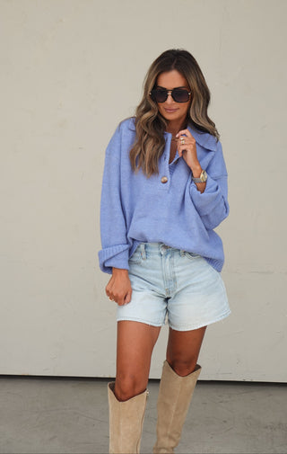 Women's blue collared slouchy knit sweater styled with light wash denim shorts