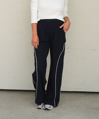 Women's black wide-leg drawstring track pants with contrast side stripe