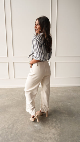 Model wearing bone suede pants with eyelet detail