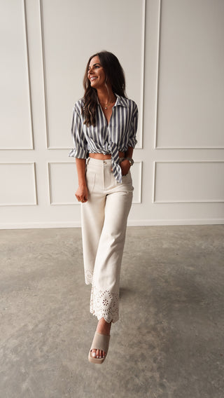 Model wearing bone suede pants with eyelet detail